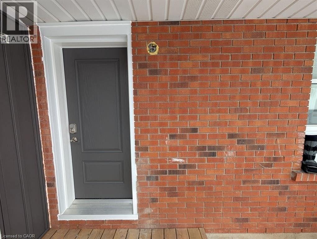 The property features a brick exterior and a dark-colored entry door with white trim
