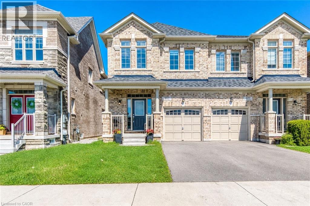 Stone facade residence featuring a covered entry porch, multiple window arrays, and an attached two-car garage with individual doors