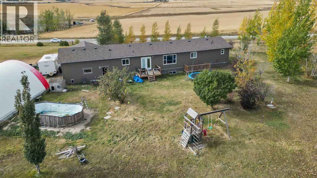 Large backyard with a deck and swing set