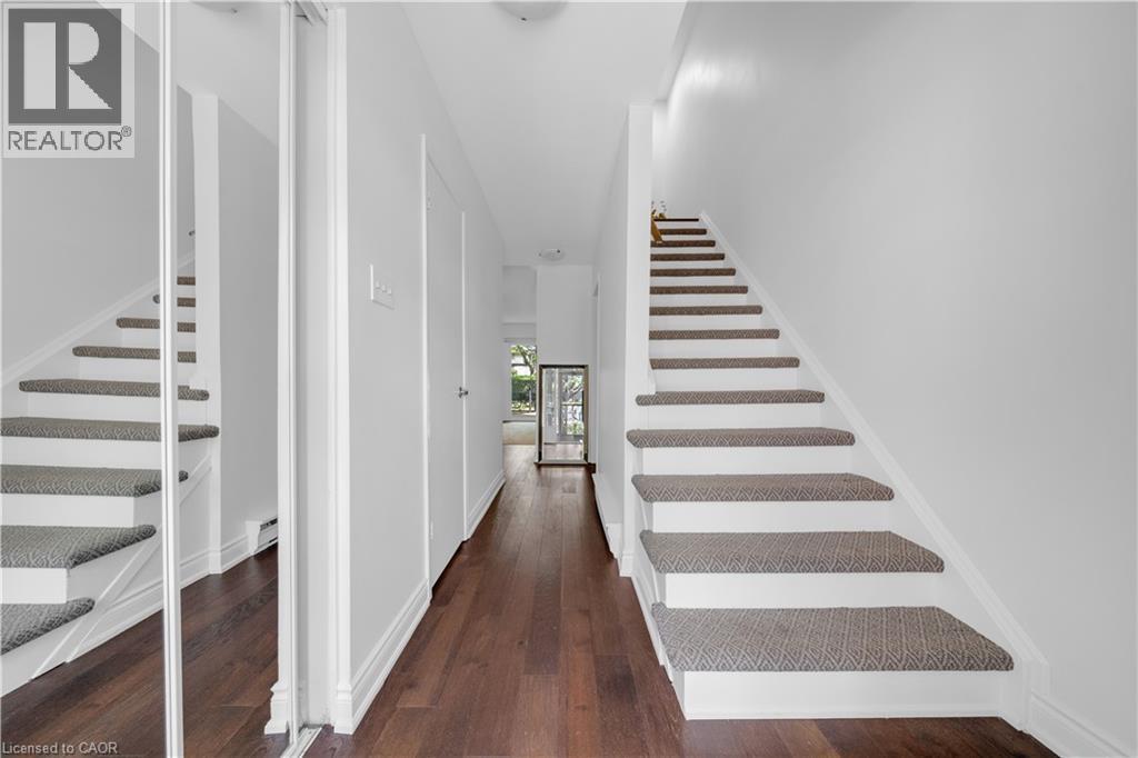 Hardwood-finish flooring extending through a brightly lit hallway