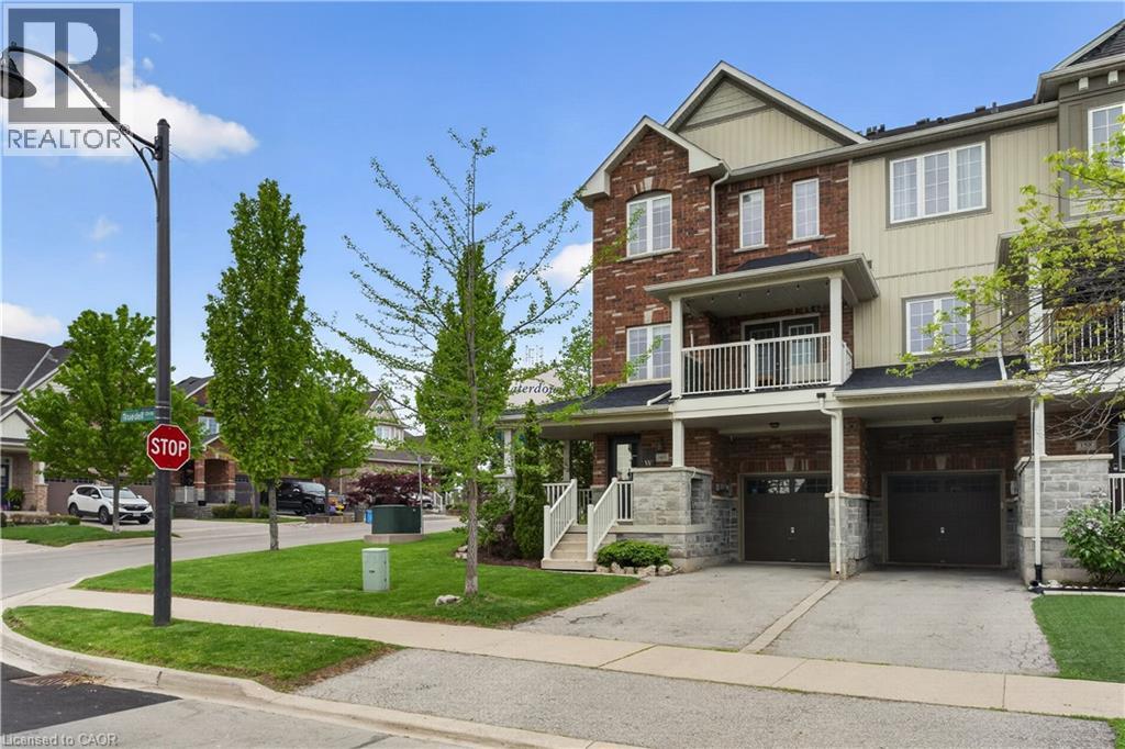 Multi-story townhouse exterior with brick and siding facade