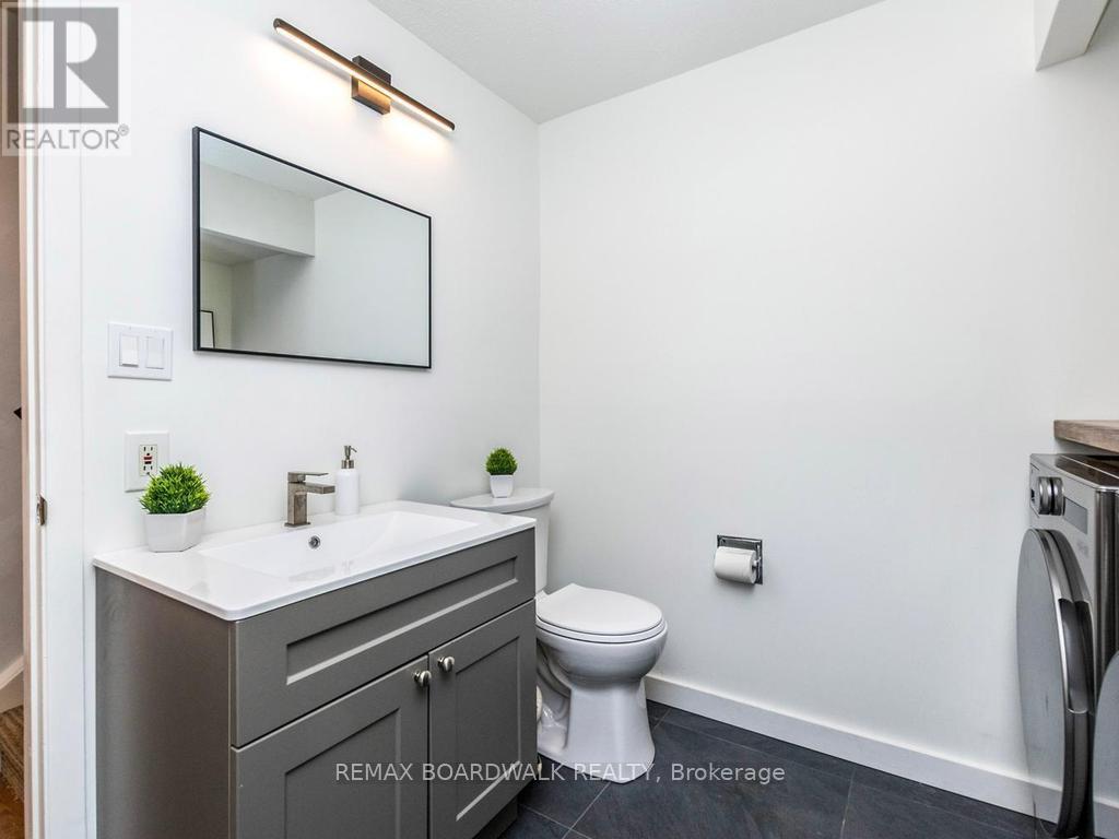 Beautifully renovated Bath & Laundry Room by Foyer