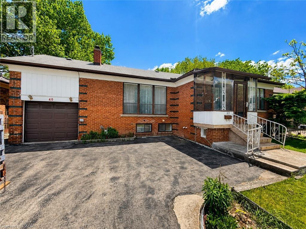 Brick facade residence featuring a front sunroom with glass panels, an attached single-car garage with a brown door, and a paved driveway