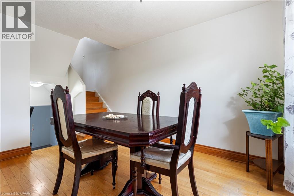 Open concept space featuring light wood-finish flooring, white walls, and wood trim