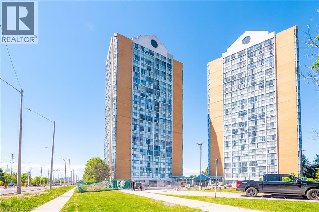 Twin high-rise residential buildings featuring extensive window facades and brick accents
