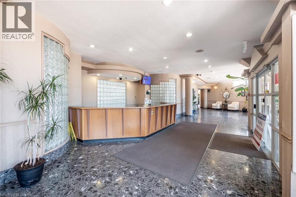 Lobby area with polished stone flooring and a wood-paneled reception desk