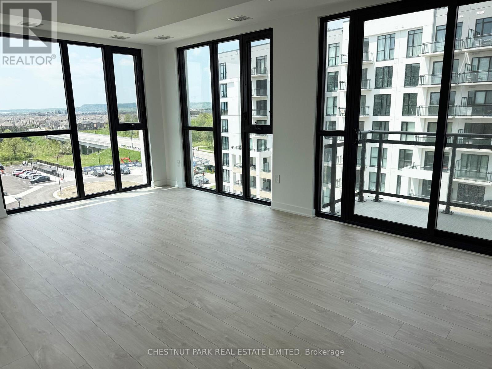 Living & dining area features wall-to-wall windows