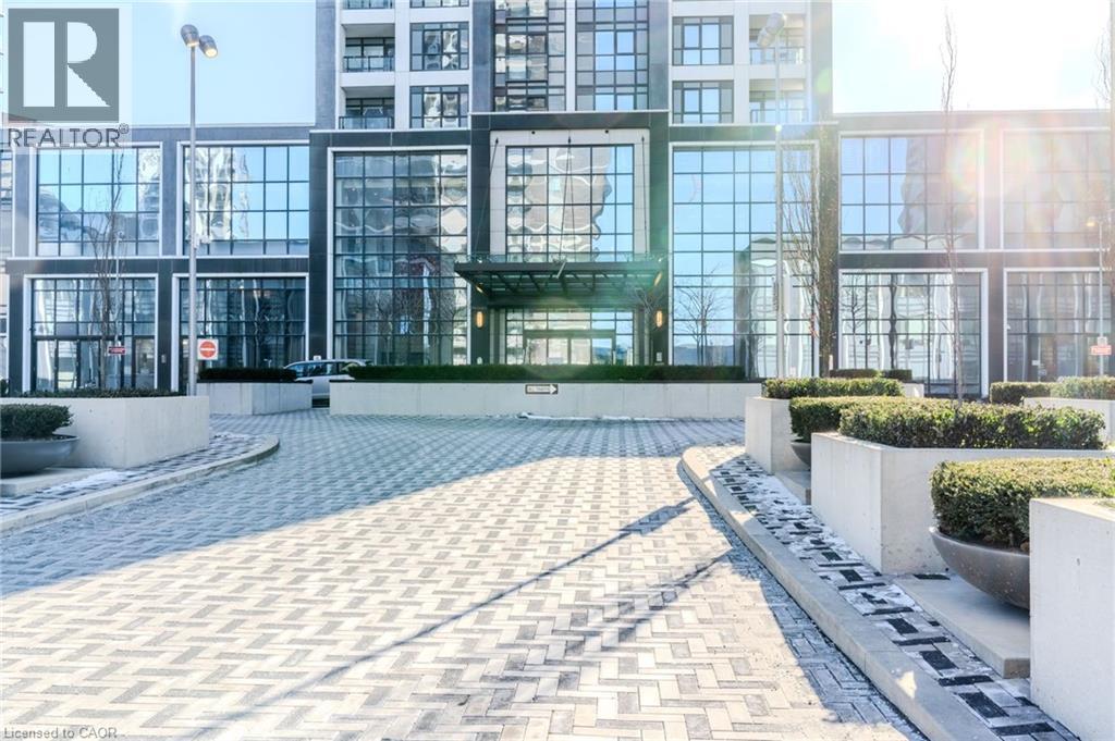 Modern building exterior featuring extensive glass facades and a prominent recessed entrance