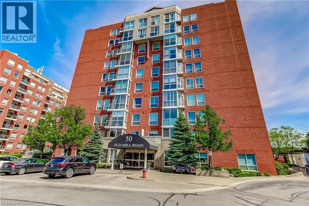 Multi-story brick building with a prominent entrance canopy