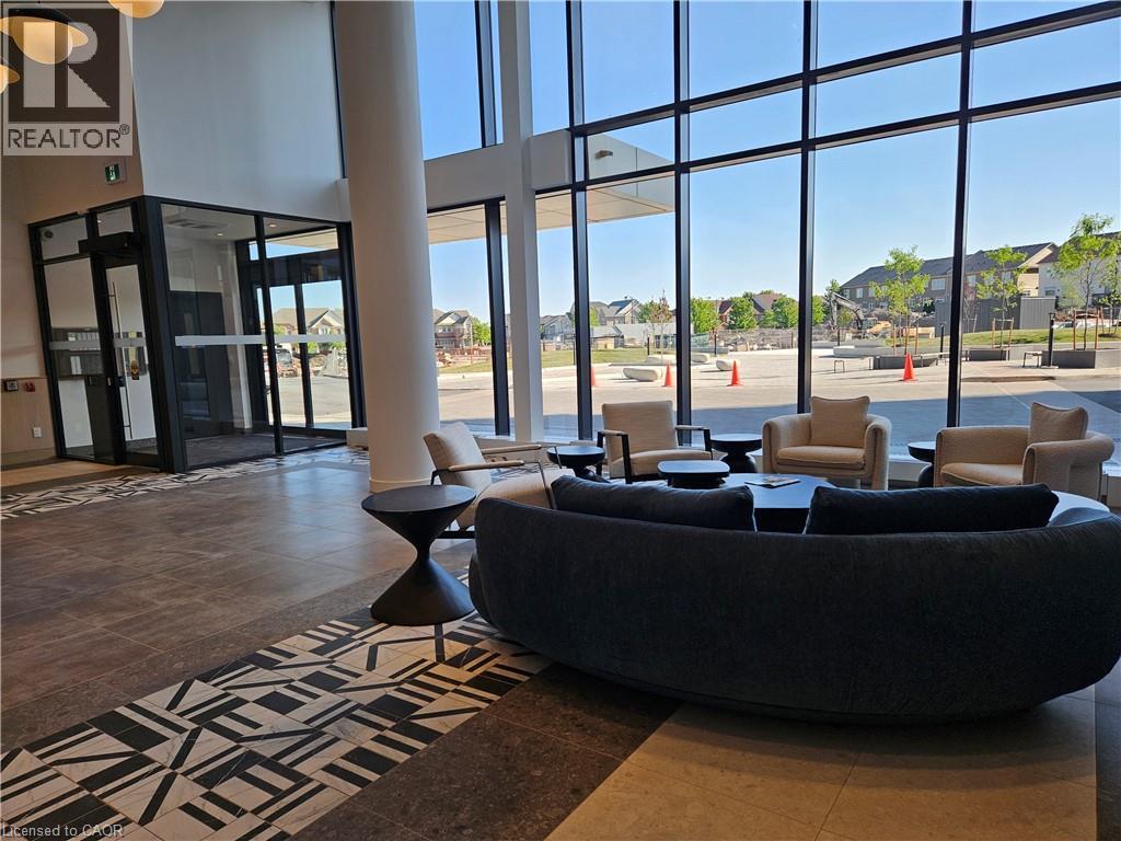 Spacious common area featuring floor-to-ceiling windows, high ceilings, and a decorative tile flooring inlay