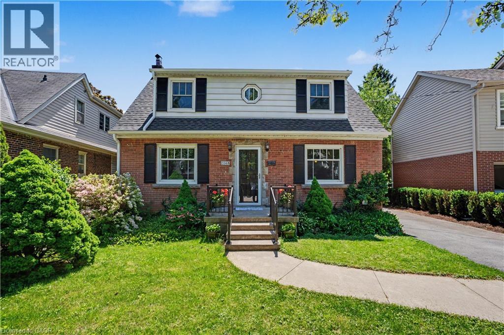 Brick facade residence featuring a front entry porch with steps and railing