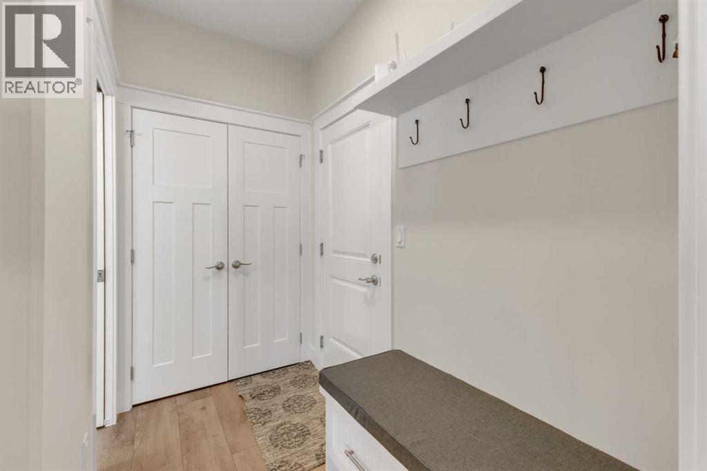 Functional mudroom with built-in bench, storage as well as direct access to the garage and a 1/2 bath