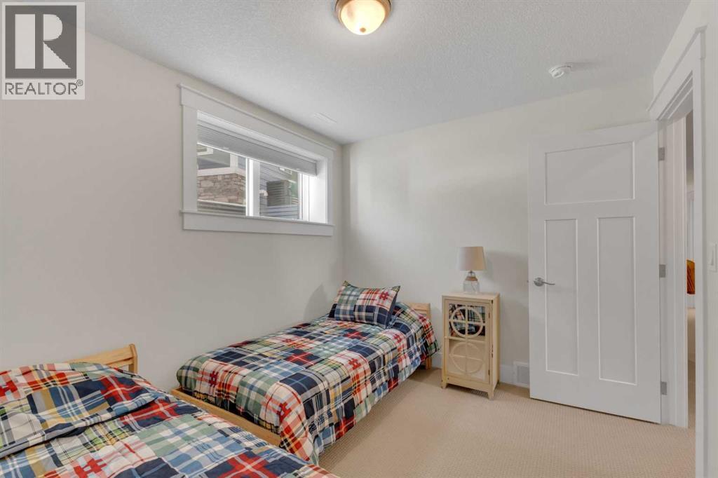 Spacious lower-level bedroom with space for two beds. Ideal for guests or kids