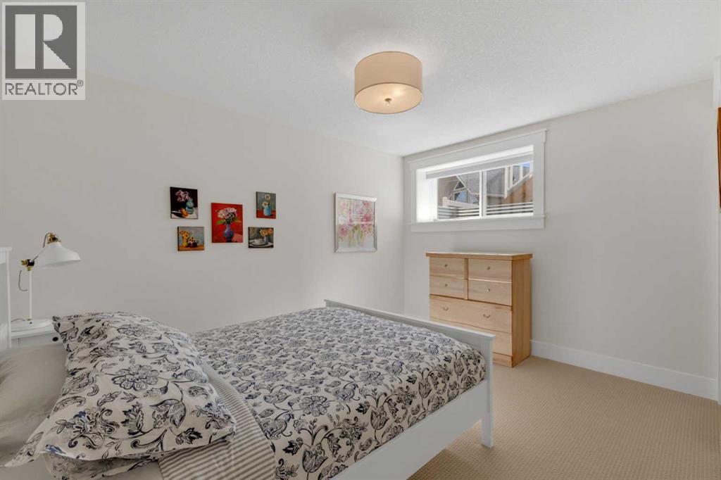 Spacious lower-level bedroom with a clean, neutral finish