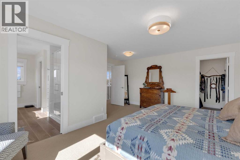 A comfortable primary bedroom with easy access to both the walk-in closet and ensuite