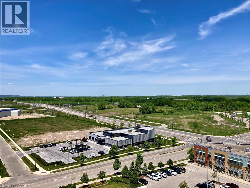 Expansive urban landscape featuring commercial structures, paved roadways, and undeveloped green spaces