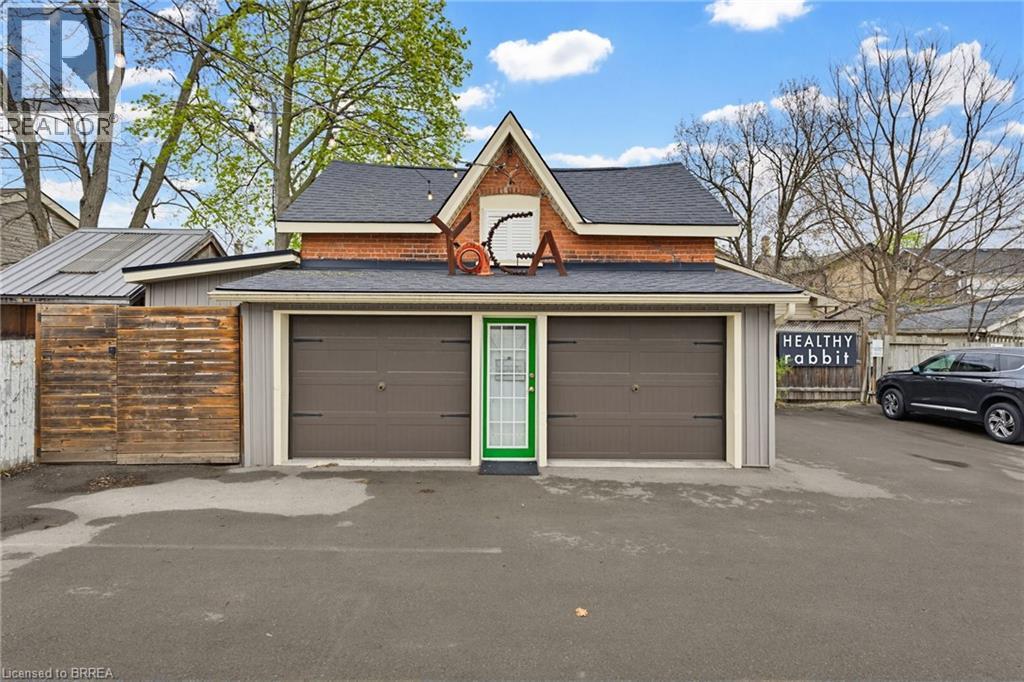 Exterior front with 2 garage doors & man door