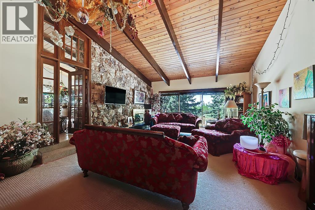 Fabulous wood panel ceiling and stone fireplace