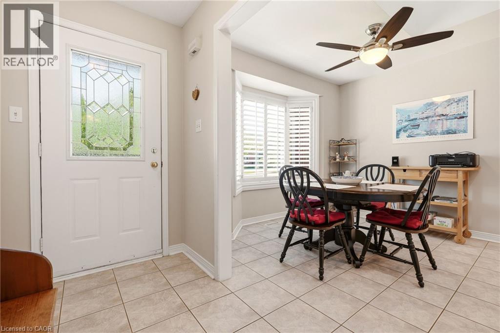 Entryway with ceramic tile flooring and a white door featuring decorative glass