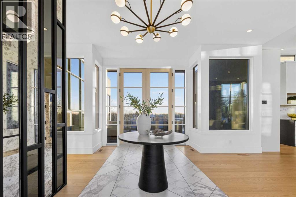 Foyer with double french doors at the end, leading to an expansive entertaining deck