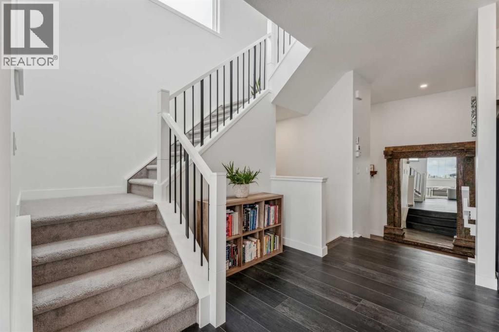 Sleek open railings complement the open-concept layout