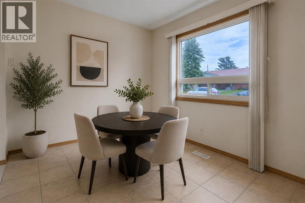 Enjoy everyday meals or morning coffee in this bright dining area overlooking the front yard. Virtually staged