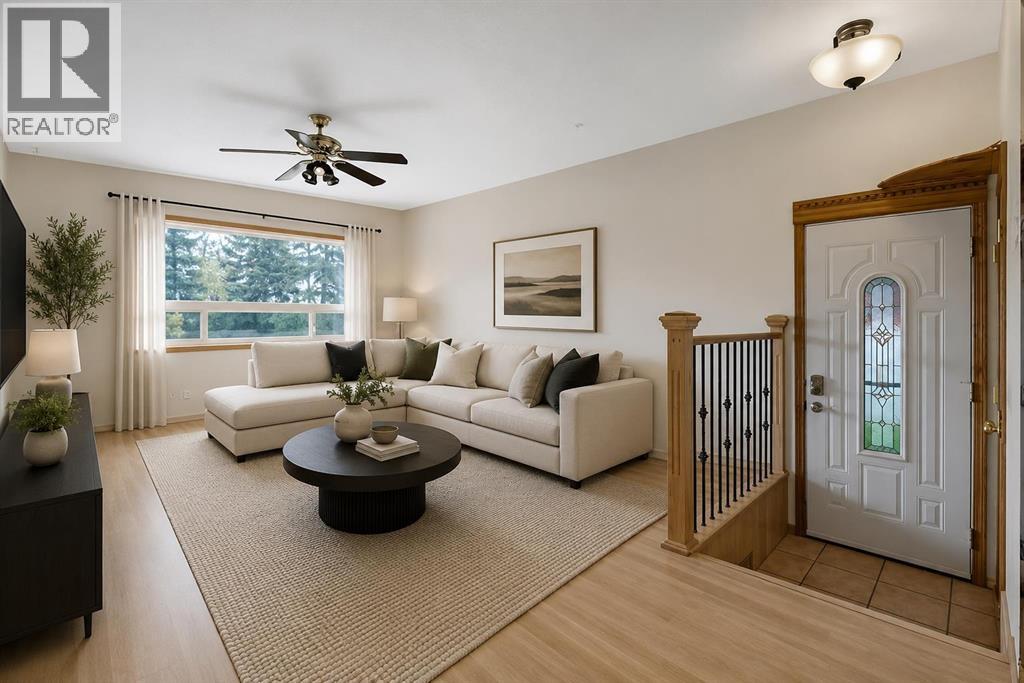 The spacious living room is filled with natural light from large windows and offers plenty of room for everyday living and entertaining. Virtually staged