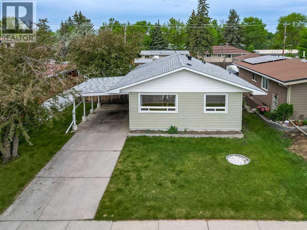 The long driveway, covered carport, and oversized garage provide exceptional parking and functionality