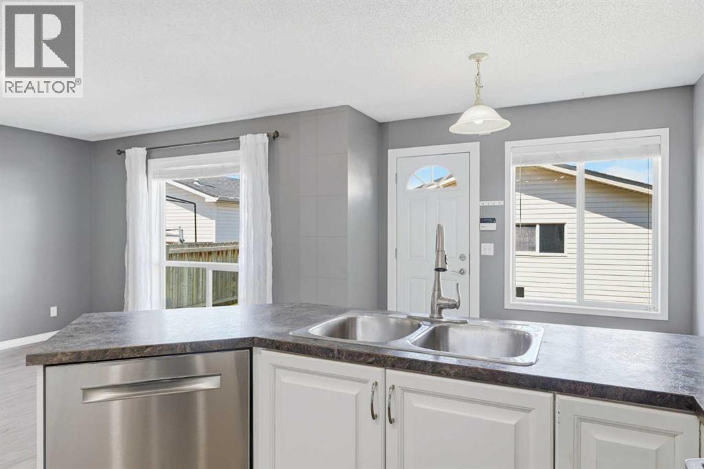 Views of the backyard and newly refinished deck while you enjoy prepping family meals in the modern kitchen