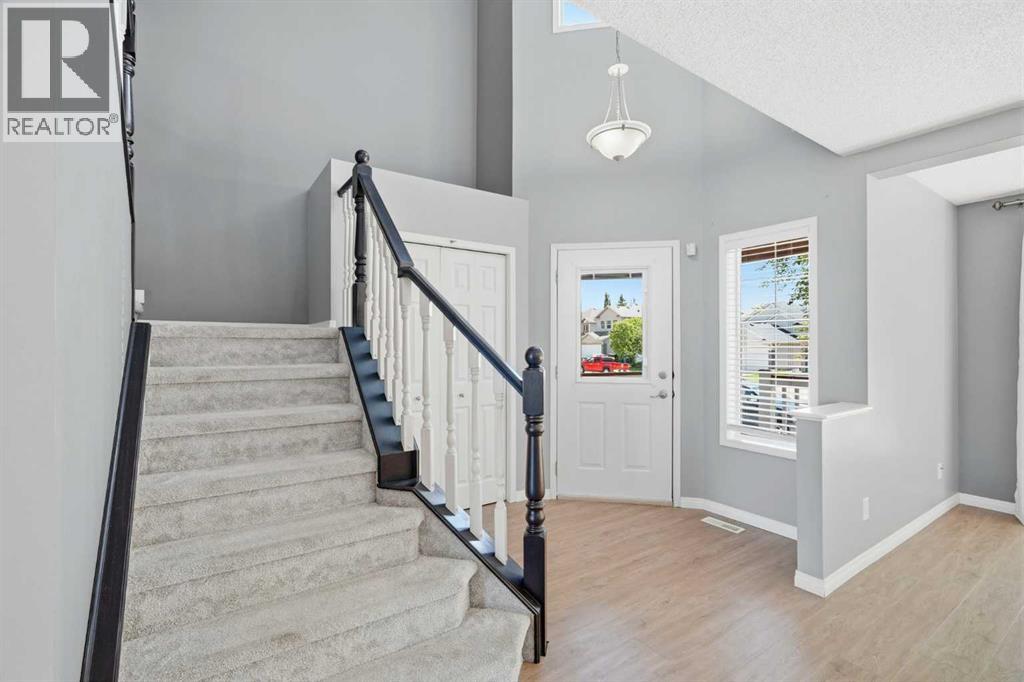 Open to below foyer and coat closet with additional foyer windows and built in blinds