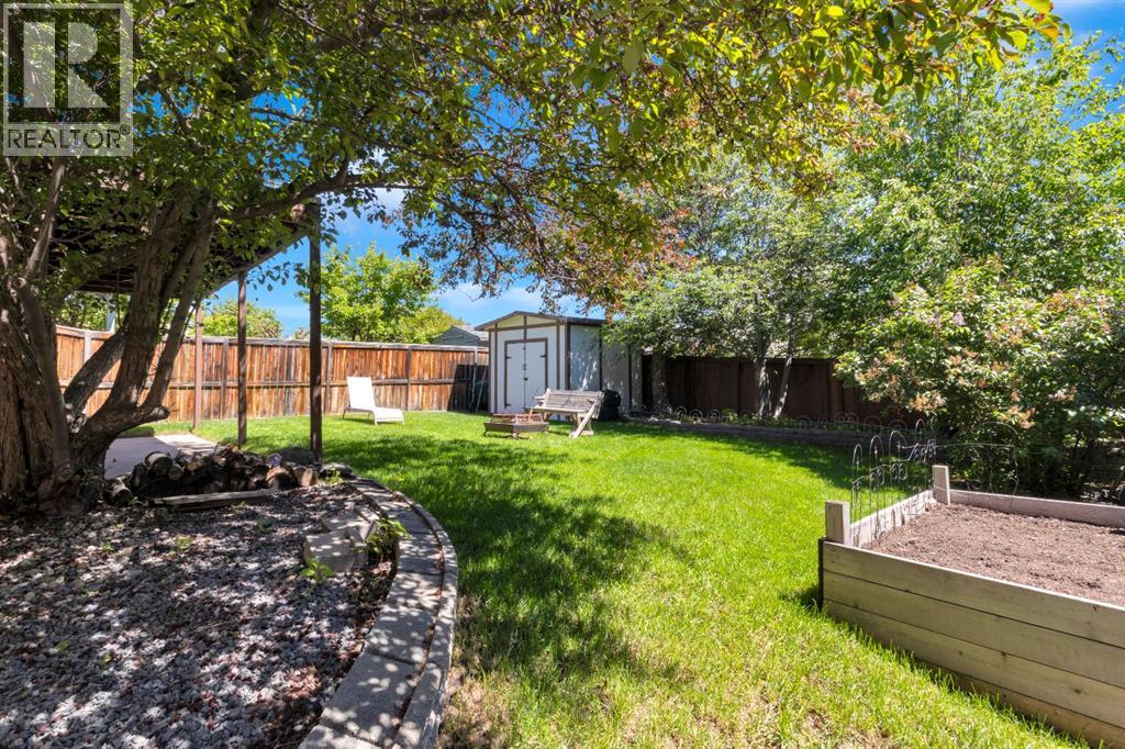 Beautiful Mature Trees and raised garden bed in the backyard