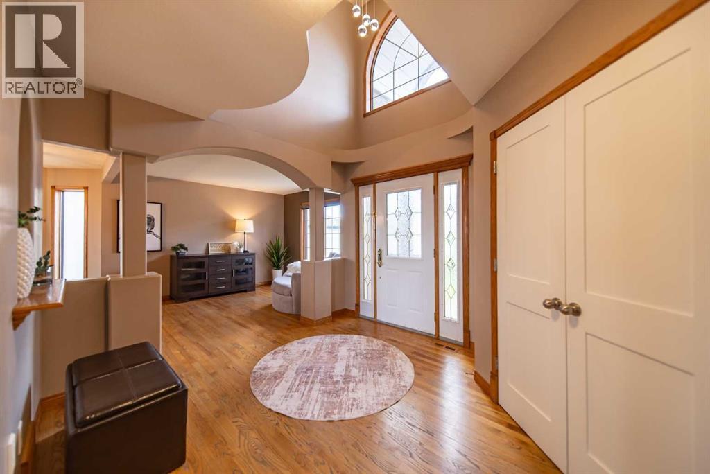 An open-to-second-floor entrance adds timeless architectural appeal and instantly feels like home, setting the tone for the rest of the home