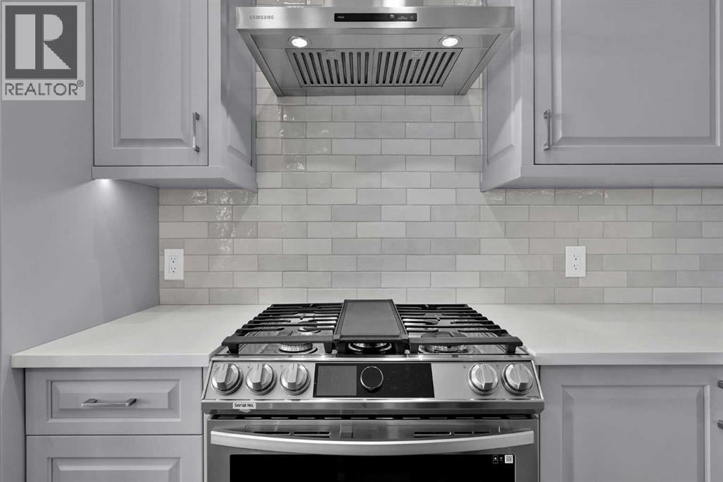 Gas range and hood fan. Streamlined backsplash