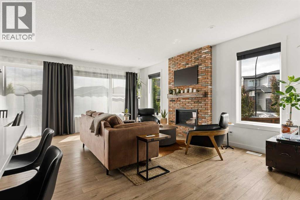 A wall of windows across the rear and side of the home fill the space with natural light
