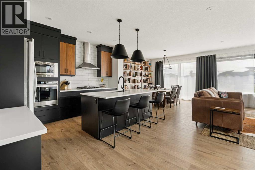 Stunning kitchen with two-tone cabinetry, built-in appliances and oversized central island