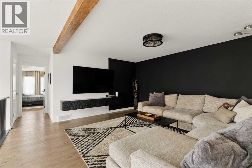 Central bonus room with resilient luxury vinyl plank flooring throughout the upper level
