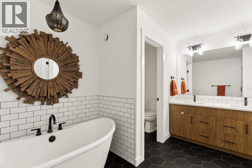 Primary ensuite with dual sinks, soaker tub and walk-in shower