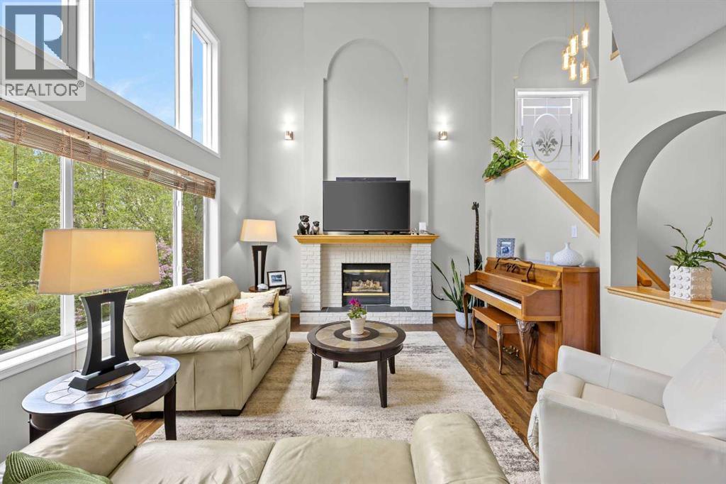 Soaring two-storey ceilings, walls of windows, and a cozy brick gas fireplace make this great room as grand as it is inviting