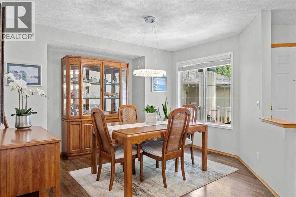 A spacious formal dining room with a stunning modern chandelier—ready to host holiday feasts and special celebrations