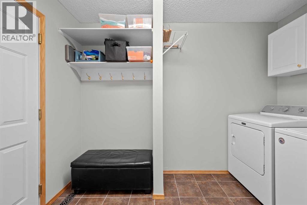 A practical main-level mudroom laundry space with built-in hooks and shelving to keep everyday life organized