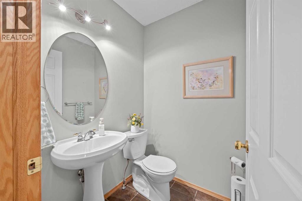 A tasteful 2-piece bath with a pedestal sink and designer finishes—convenient for guests and family alike