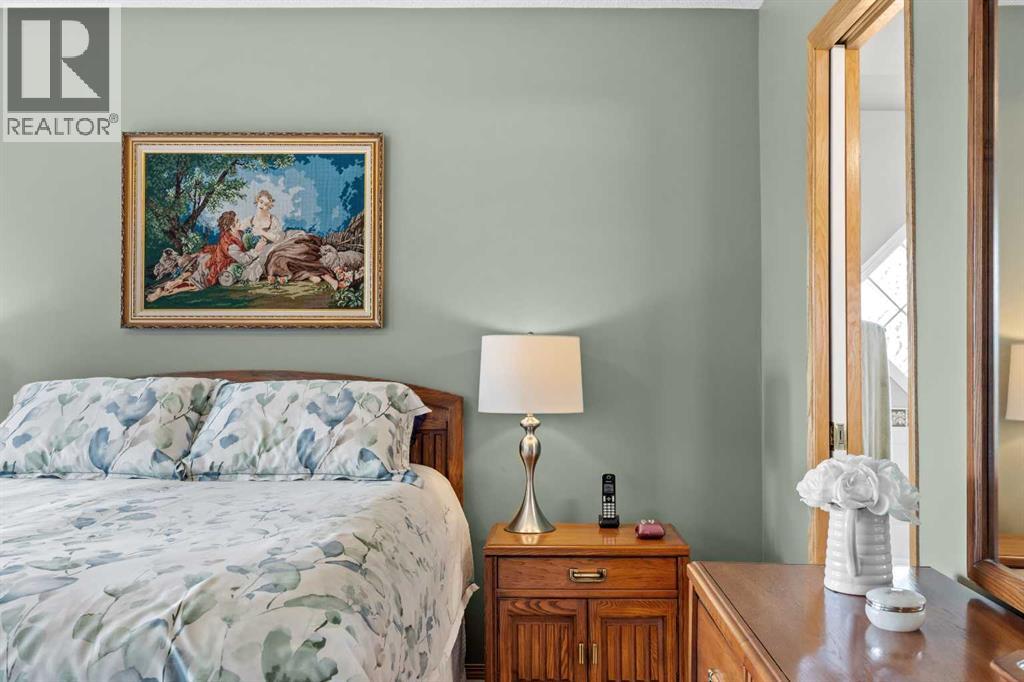 Thoughtful touches and warm natural light make this primary retreat feel calm, restful, and effortlessly inviting