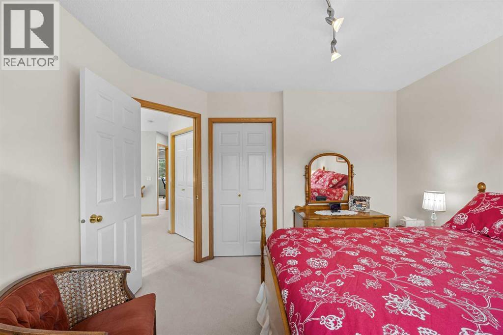 A comfortable second bedroom with double closets and serene views—ideal for children, guests, or family