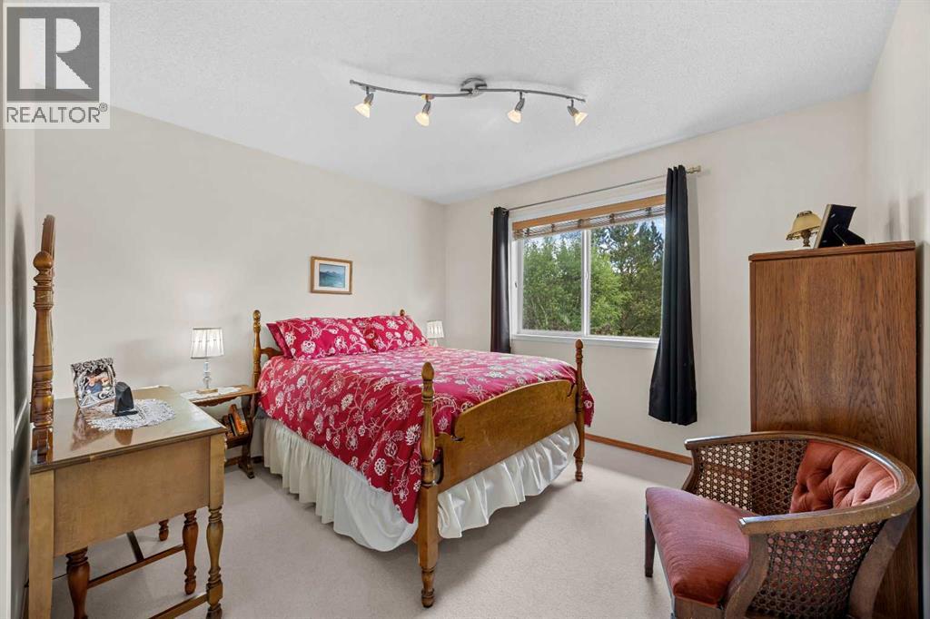 A bright, generous bedroom filled with natural light—versatile space for sleeping, study, or play