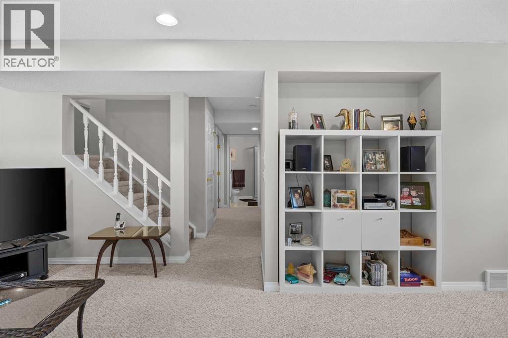 The fully developed lower level opens to a bright family room with built-in shelving and easy access to the lower bedroom and bath