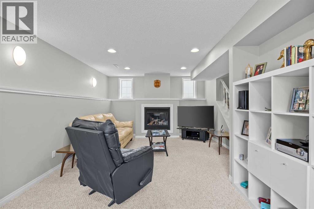 A cozy gas fireplace anchors the lower family room, the perfect spot for movie nights, game days, and relaxed evenings in