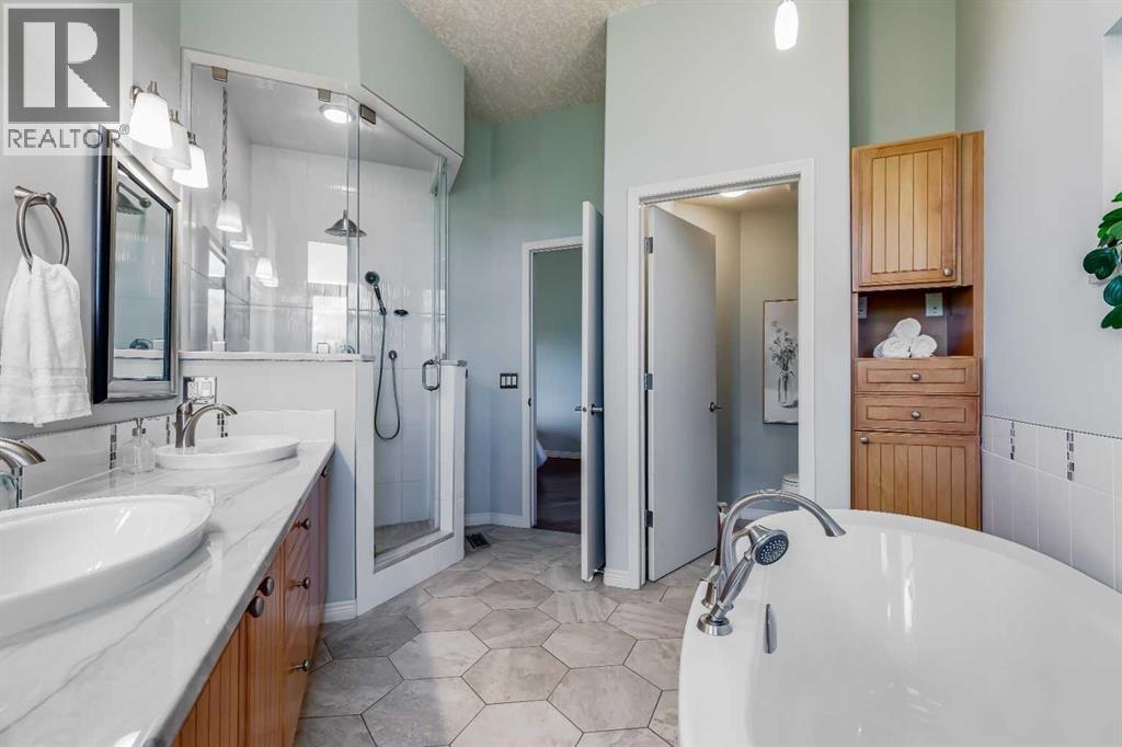 Luxurious 5-pc ensuite with double sinks and a private water closet area