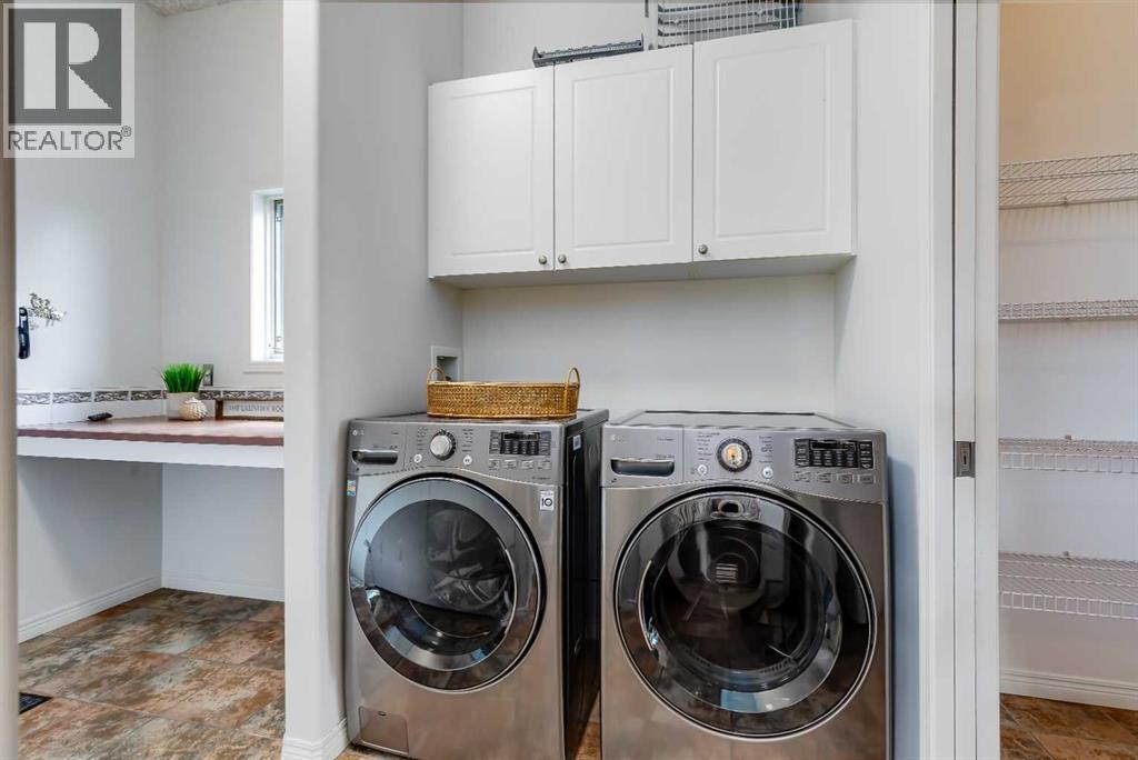 Newer washer and dryer located at the back entrance leading to the garage