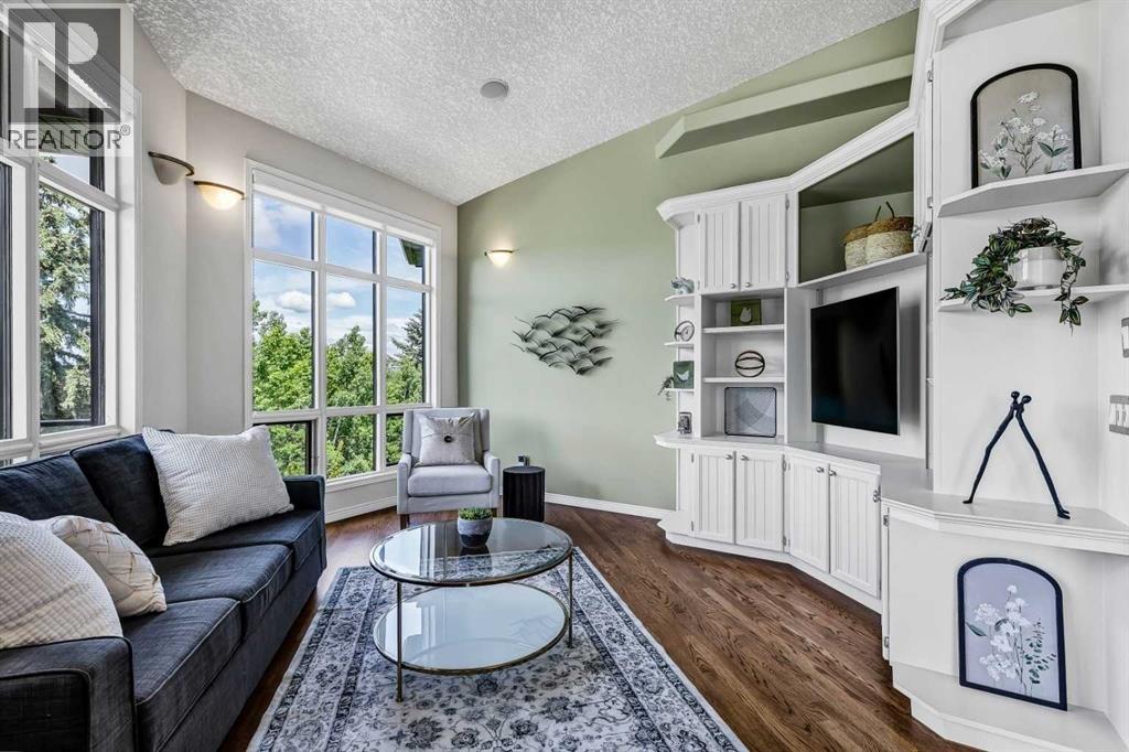 Elegant Living room featuring beautiful custom-built-in shelving
