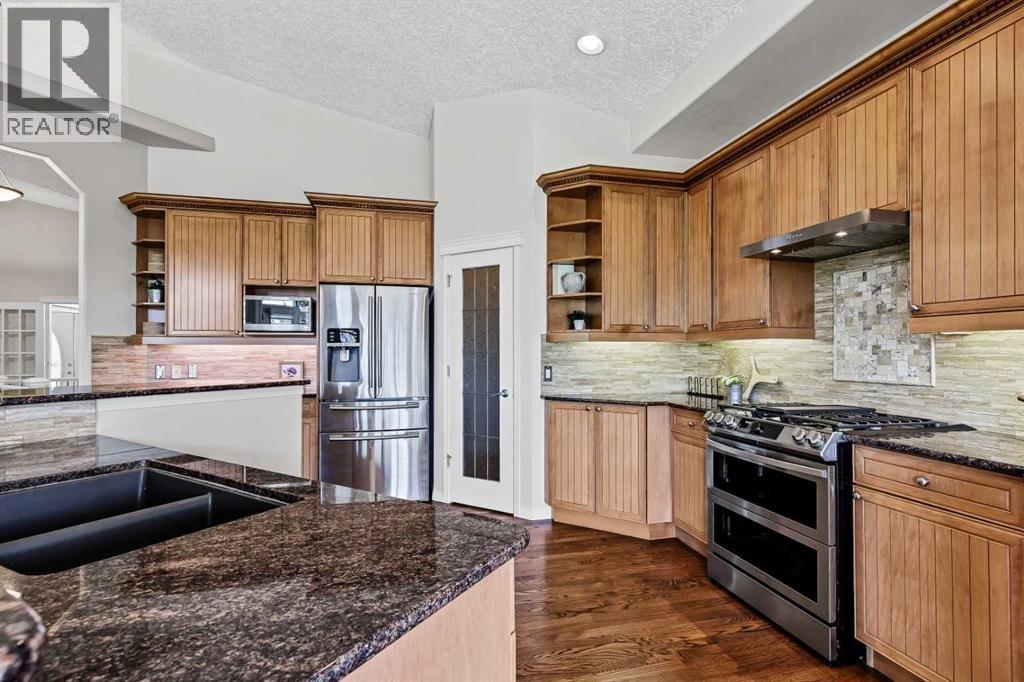 Upgraded stainless steel appliances, including a gas stove with a convection double oven